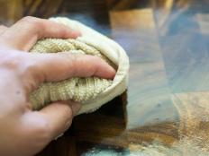 Hand Wiping Wood Cutting Board with a Towel