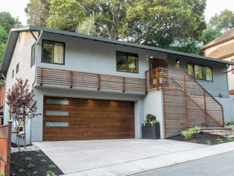 The exterior of Drew Scott’s house after renovation features new paint, wood accents, landscaping, and the removal of an overgrown tree to let more light in, as seen on Brother vs Brother. (Before 0003).